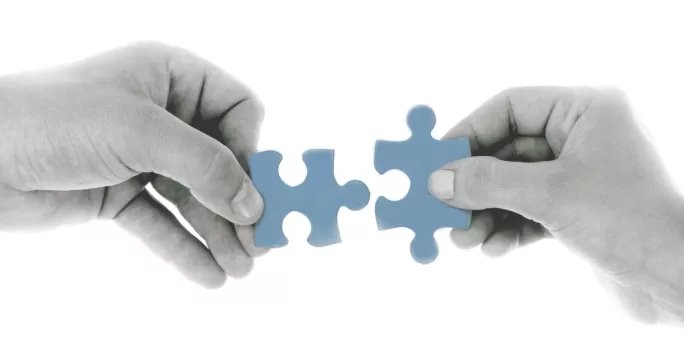 Two hands holding a puzzle piece in collaboration. Illustration.